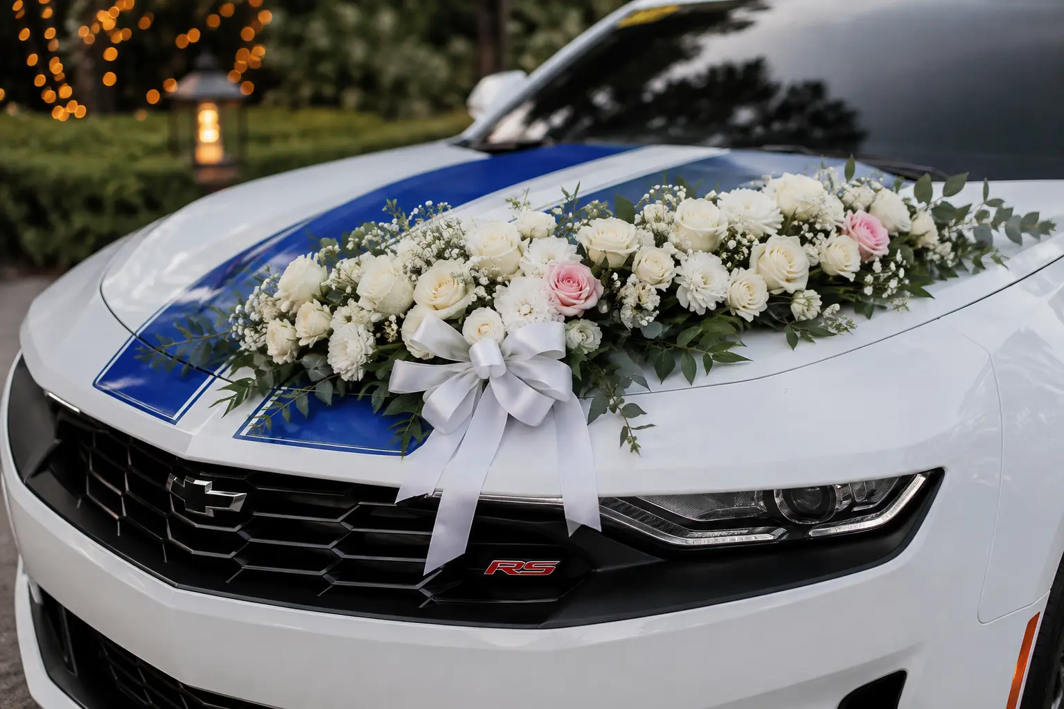 Close-up of the bridal floral arrangement on the Camaro RS hood with blue rally stripes